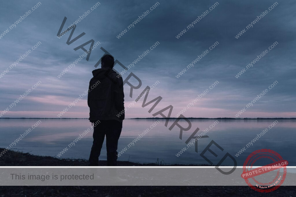 Person Standing Near Lake