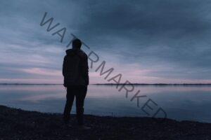 Person Standing Near Lake